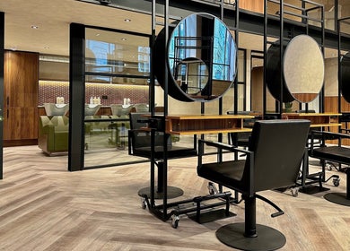 Inside view of Annette Linn Hair salon in London, England. Modern design with chic mirrors and styling chairs.