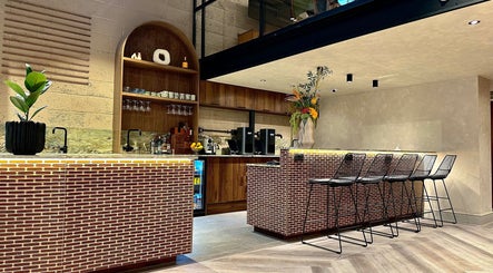 Modern bar counter with seating at Annette Linn Hair, London, England, GB.