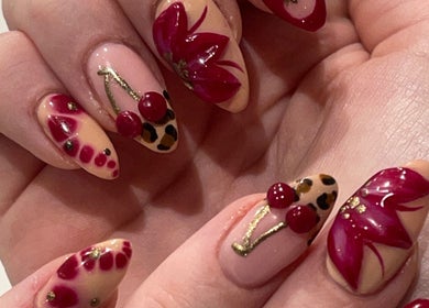 Stylish nail art with red flowers and cherries at By Kayleigh Marie, Gateshead, England, GB.