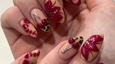 Stylish nail art with red flowers and cherries at By Kayleigh Marie, Gateshead, England, GB.