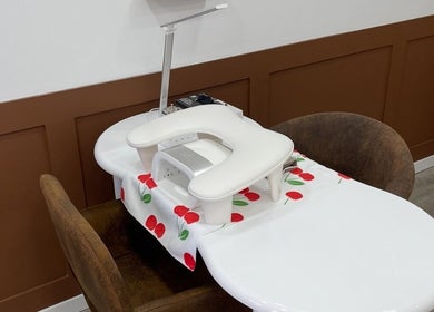 Stylish manicure table setup at By Kayleigh Marie, Gateshead, England, GB with modern decor and comfortable seating.