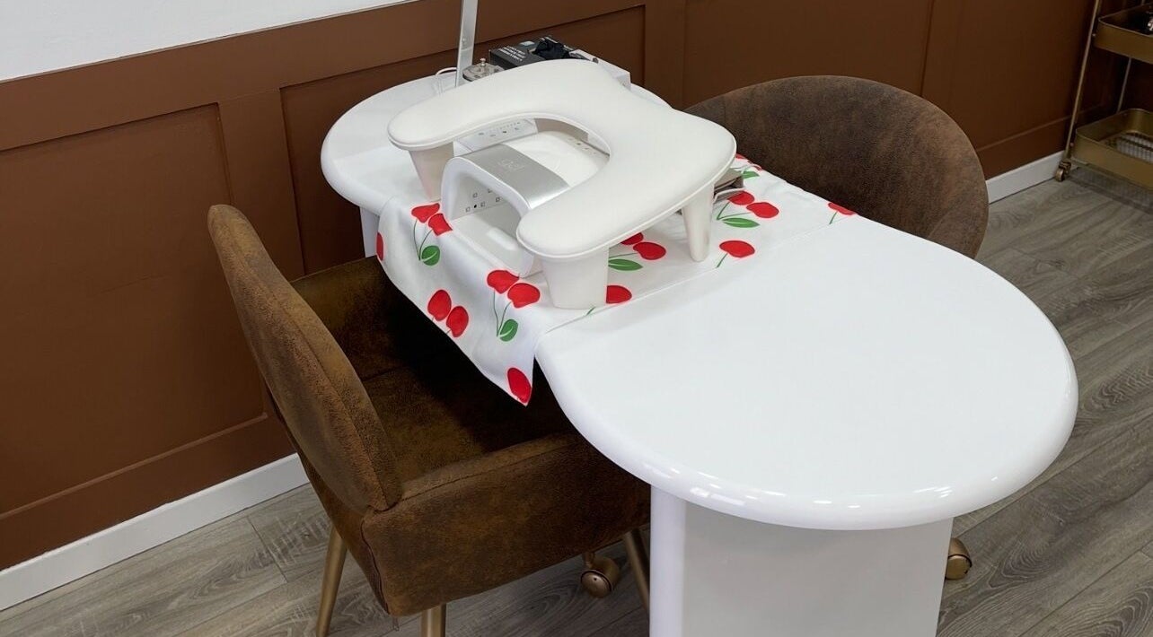 Elegant manicure station setup at 108Nails, Gateshead, England, GB, with brown chairs and a stylish table.