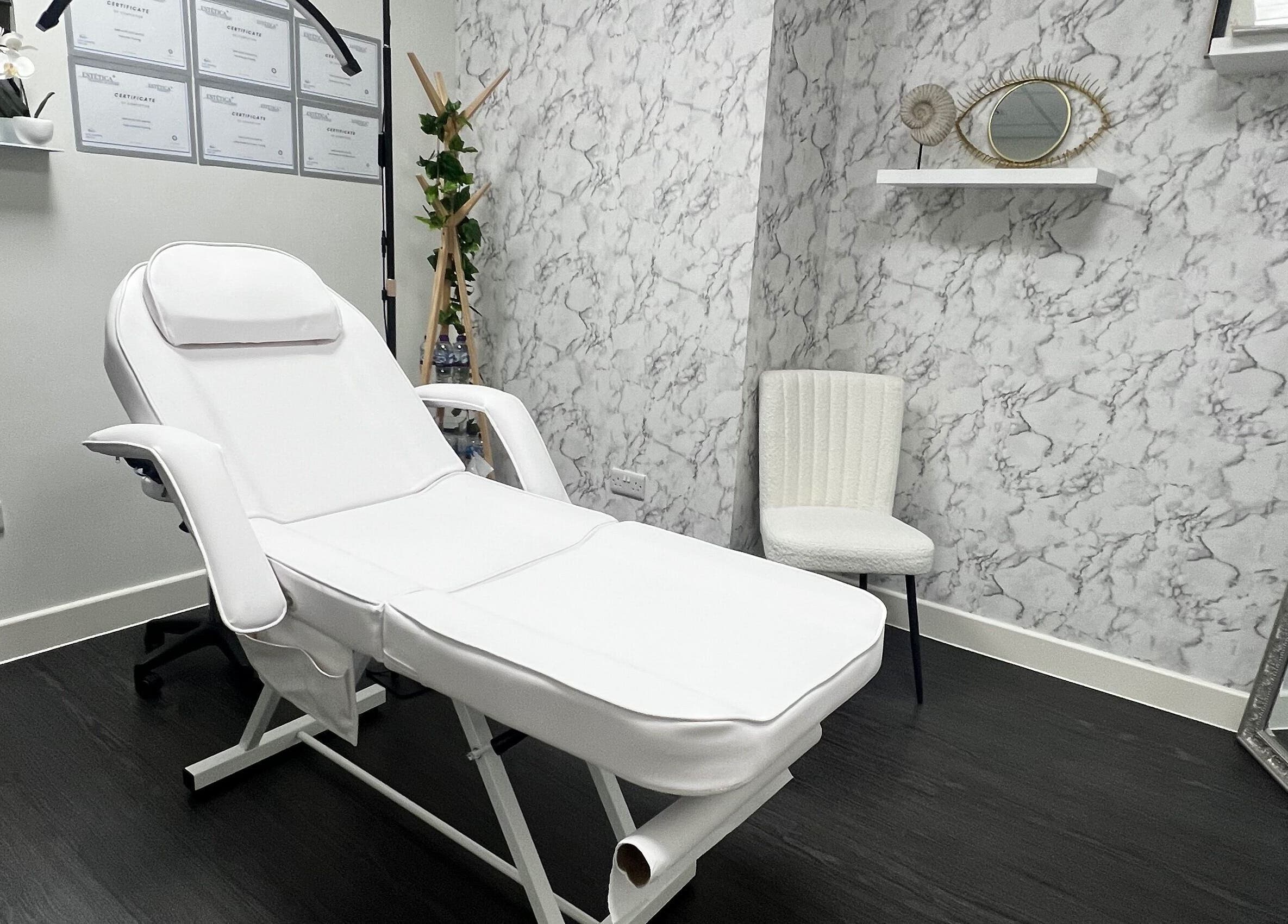 Relaxing treatment room at Aesthetic by Sara Alves, Liverpool, England, GB, with a luxurious white spa chair.