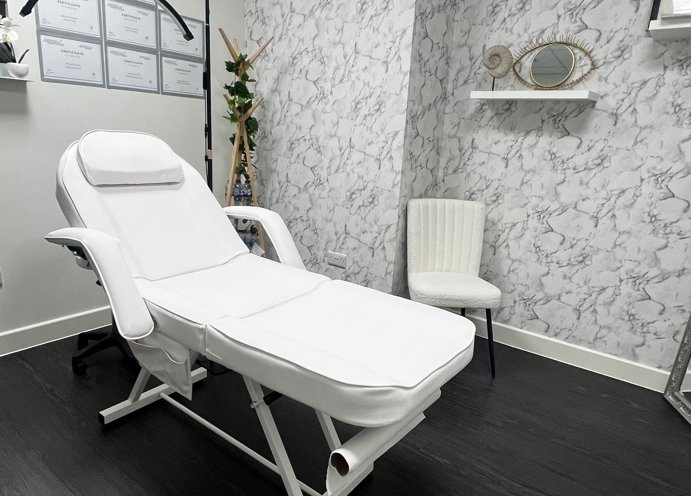 Relaxing treatment room at Aesthetic by Sara Alves, Liverpool, England, GB, with a luxurious white spa chair.