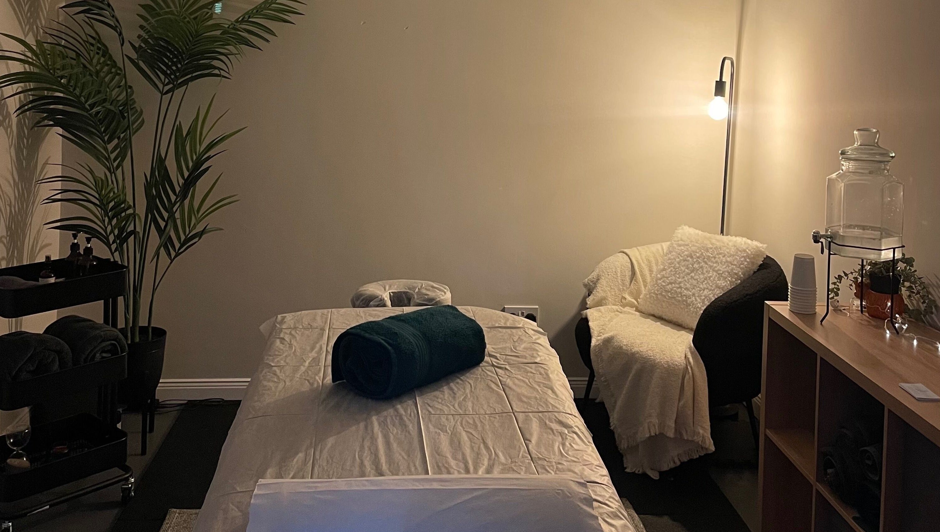 Relax and Recover treatment room in Bangor, Northern Ireland, GB with cozy lighting and a plush treatment bed.