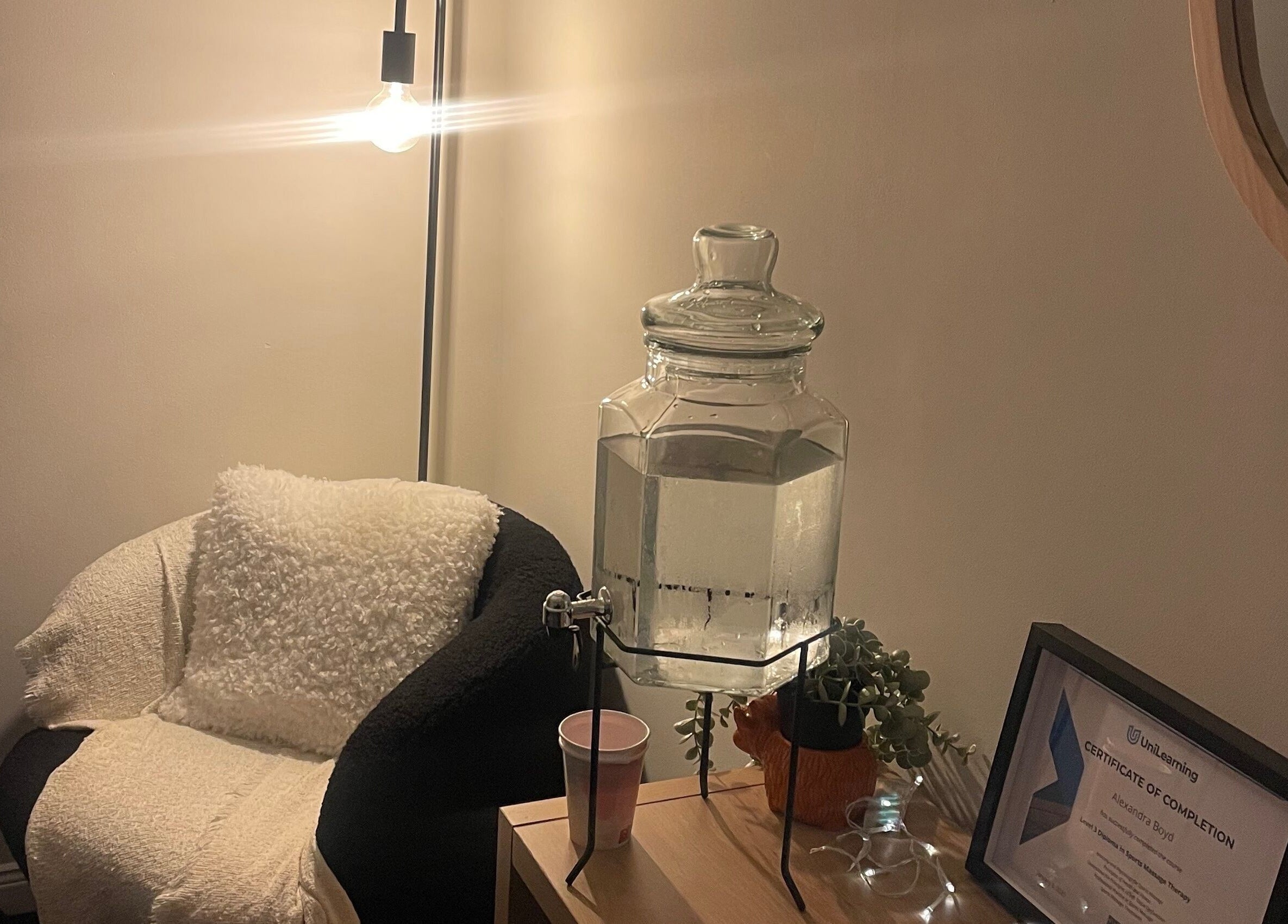 Calm seating area at Relax and Recover, Bangor, Northern Ireland, GB, featuring a water dispenser and cozy chair.