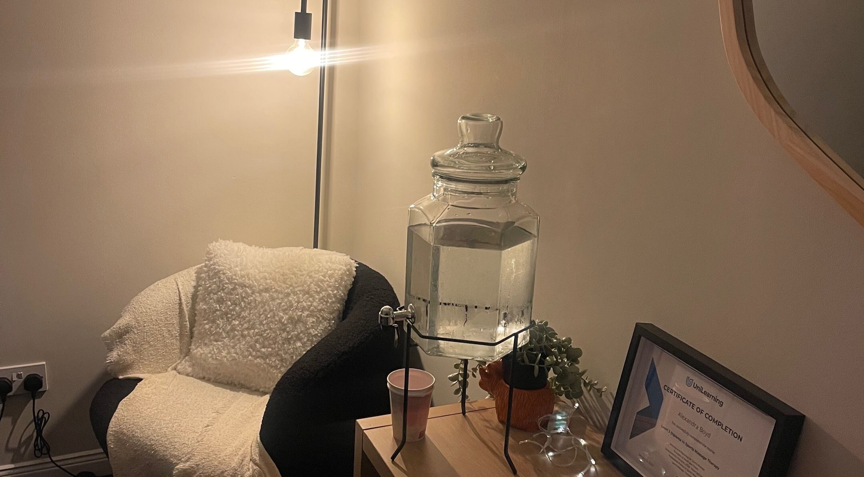 Calm seating area at Relax and Recover, Bangor, Northern Ireland, GB, featuring a water dispenser and cozy chair.