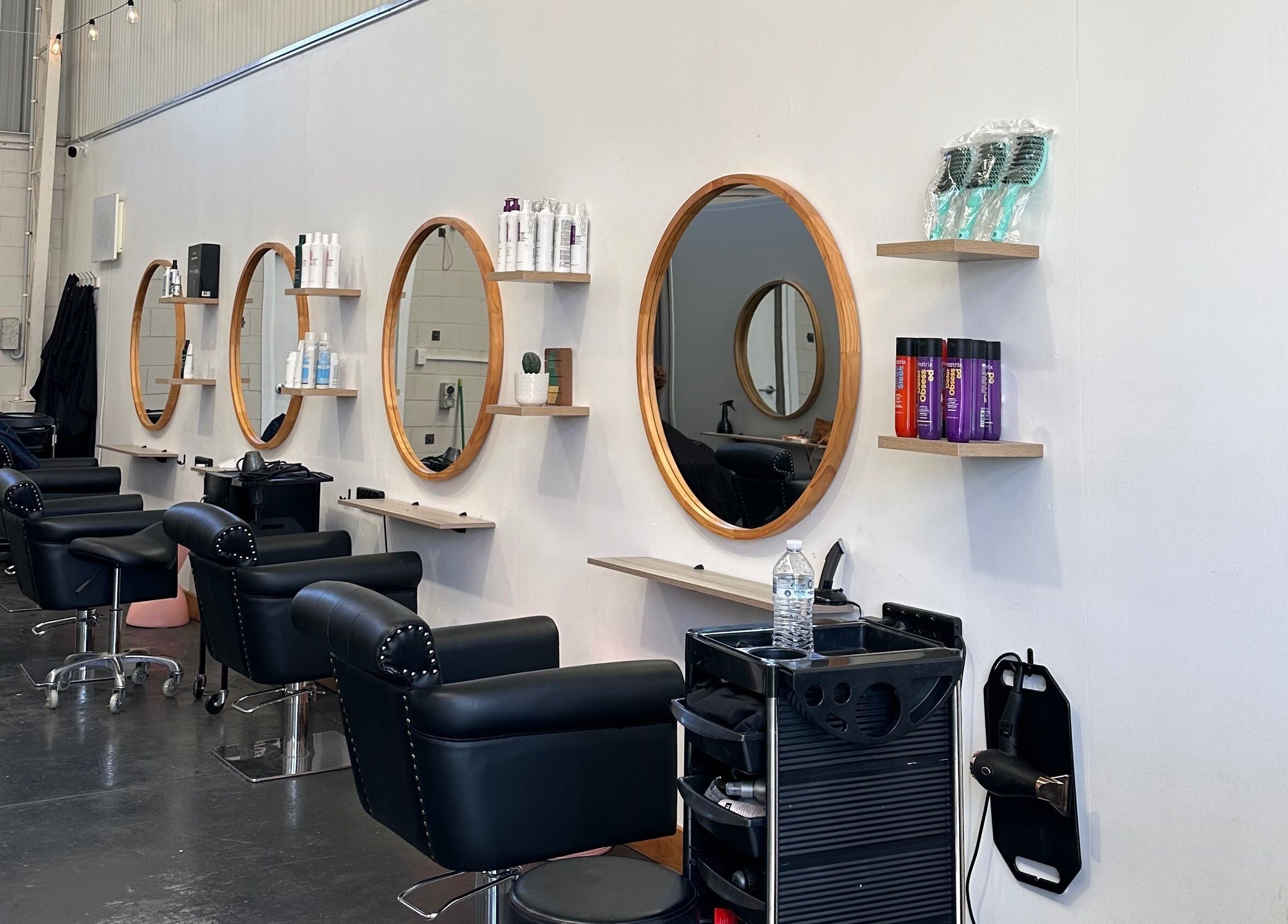 Stylish salon mirrors and chairs at Gracy RV in Yeerongpilly, Queensland, AU, showcasing modern design.