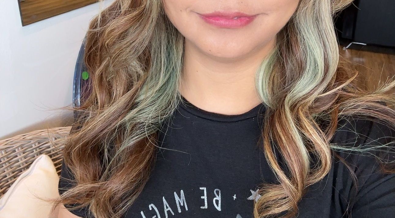 Elegant wavy hairstyle at Gracy RV, Yeerongpilly, Queensland, AU showcasing layered blond highlights.