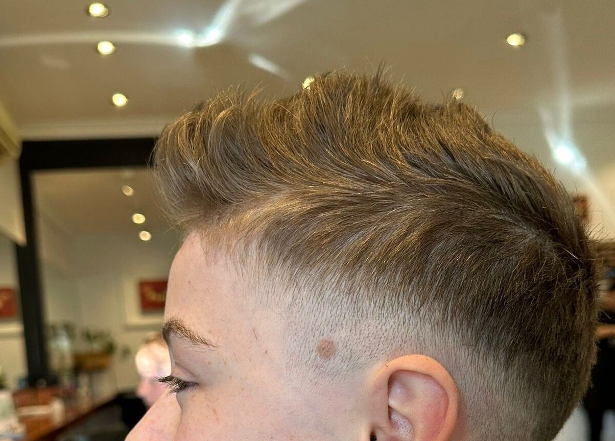 Modern short haircut at Gracy RV, Yeerongpilly, Queensland, AU. Stylish interior complements the grooming experience.