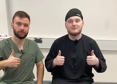 Two therapists from TruAura Mobile Massage giving thumbs up at Cardiff, Wales, GB.