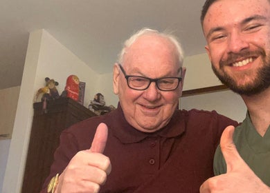 Two smiling people giving thumbs up at TruAura Mobile Massage, Cardiff, Wales, GB.