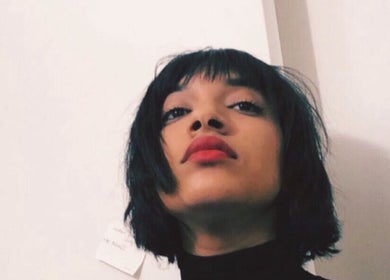Stylish woman with short black hair and red lipstick at YUDELKA HAIR - 1er - MARTHA, Paris, Île-de-France, FR.