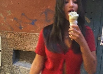 Stylish woman enjoying gelato in Paris, captured near YUDELKA HAIR - 1er - MARTHA, Île-de-France, FR.