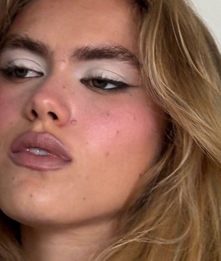 Close-up of elegant makeover at Yudelka Hair, Paris, Île-de-France, FR showcasing subtle makeup and styled hair.