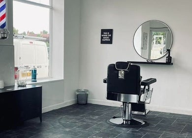 Sophisticated barber chair at Eden At Jacks Barbers in Clipstone, England, GB with sleek decor and large mirror.