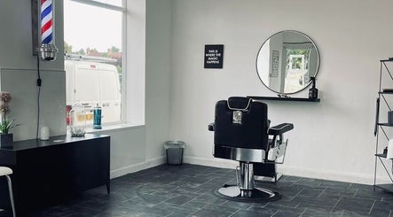Sophisticated barber chair at Eden At Jacks Barbers in Clipstone, England, GB with sleek decor and large mirror.