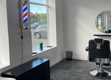 Modern barber chair and mirror at Eden At Jacks Barbers, Clipstone, England, GB.