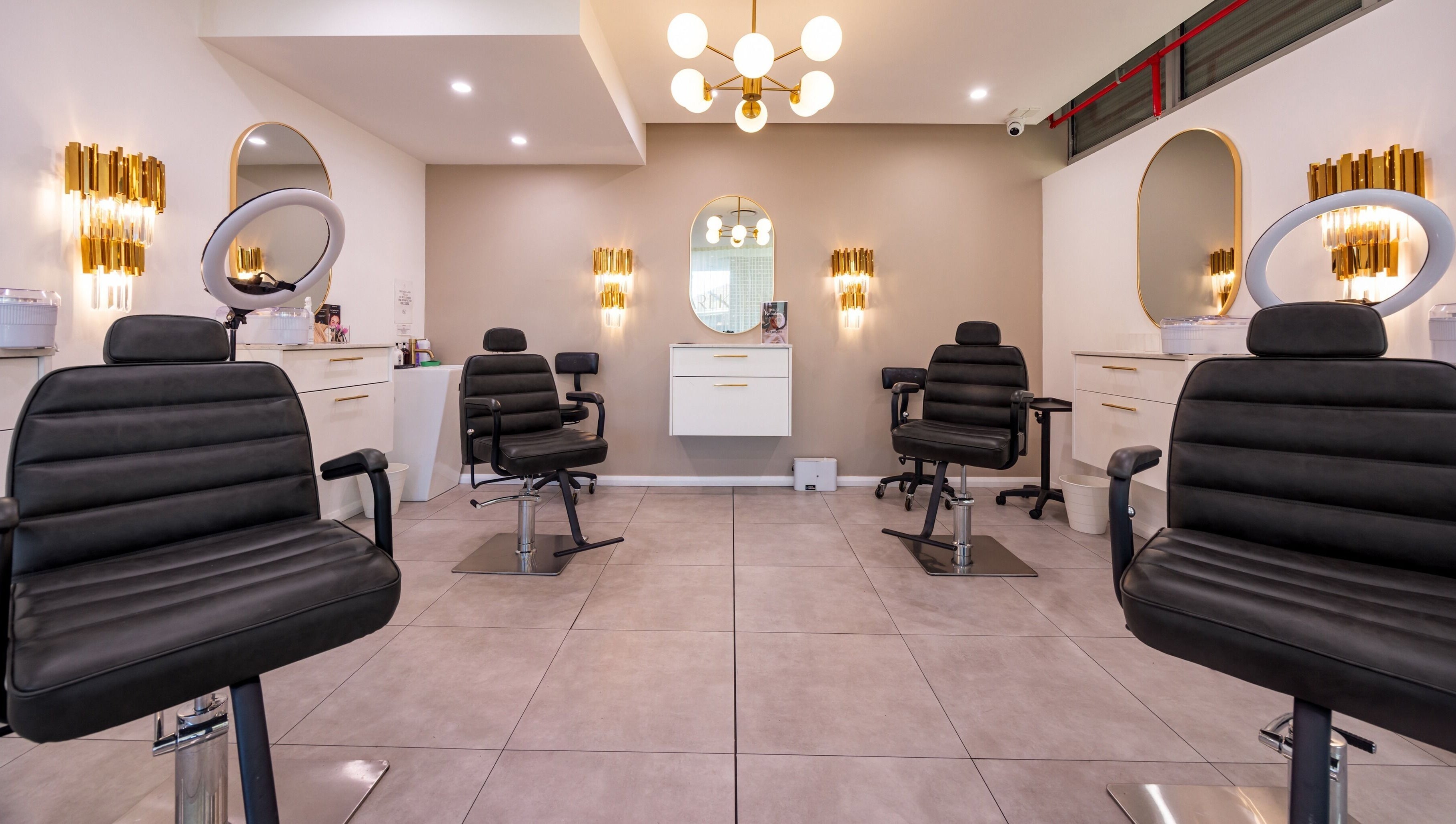 Chic interior of Lana Tarek Eyebrow Specialists in Ashfield, New South Wales, featuring modern salon chairs.