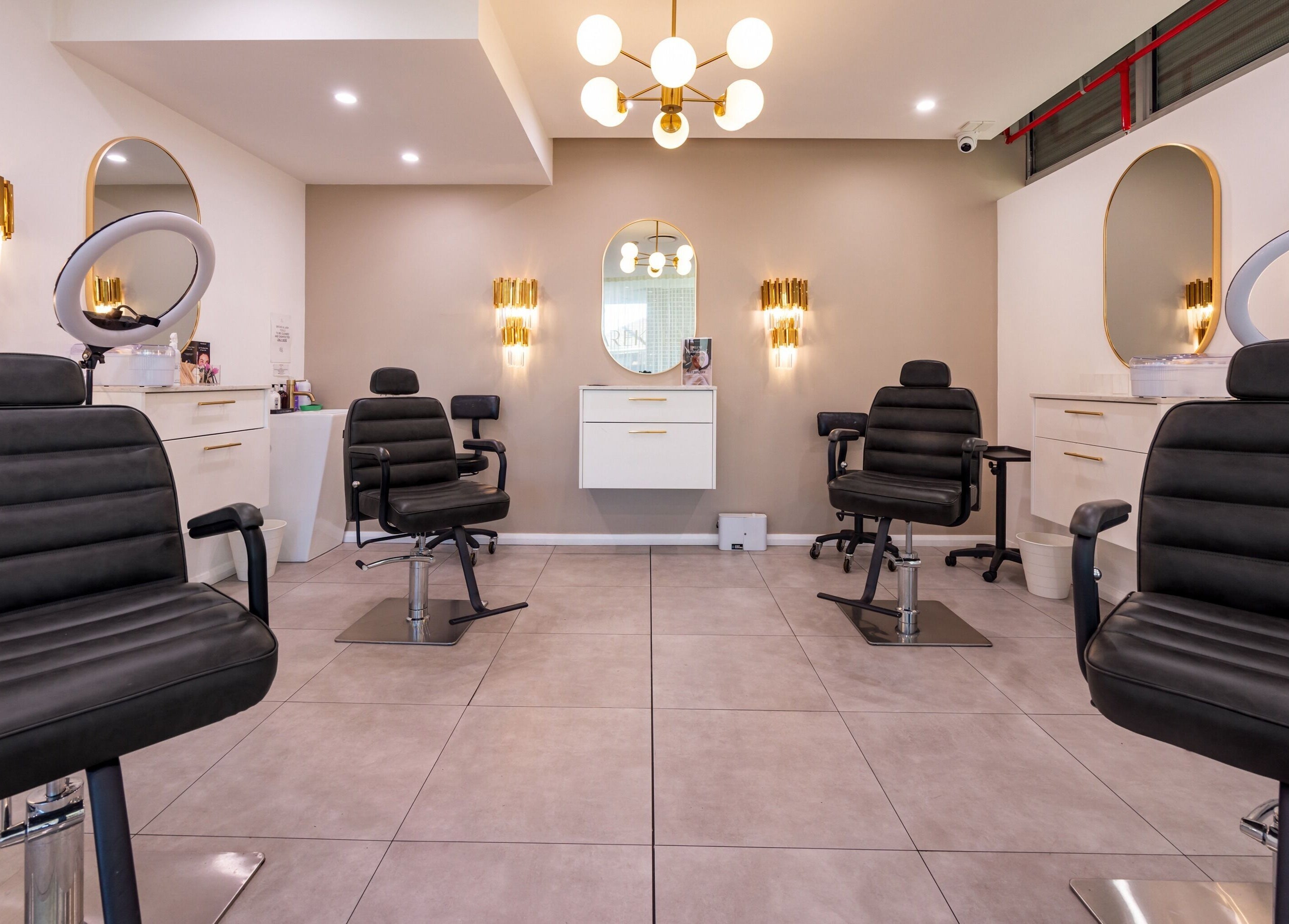 Chic interior of Lana Tarek Eyebrow Specialists in Ashfield, New South Wales, featuring modern salon chairs.