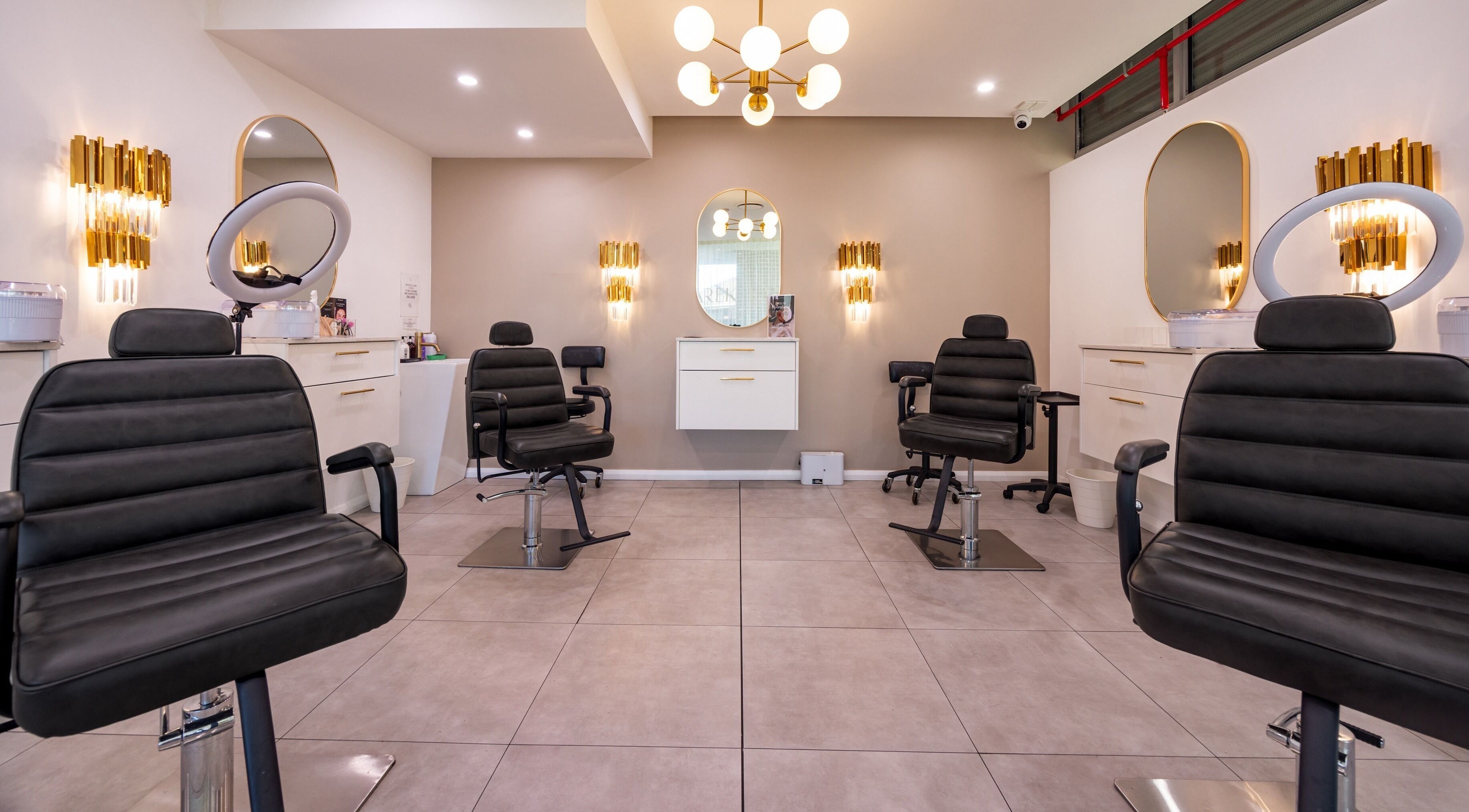 Chic interior of Lana Tarek Eyebrow Specialists in Ashfield, New South Wales, featuring modern salon chairs.