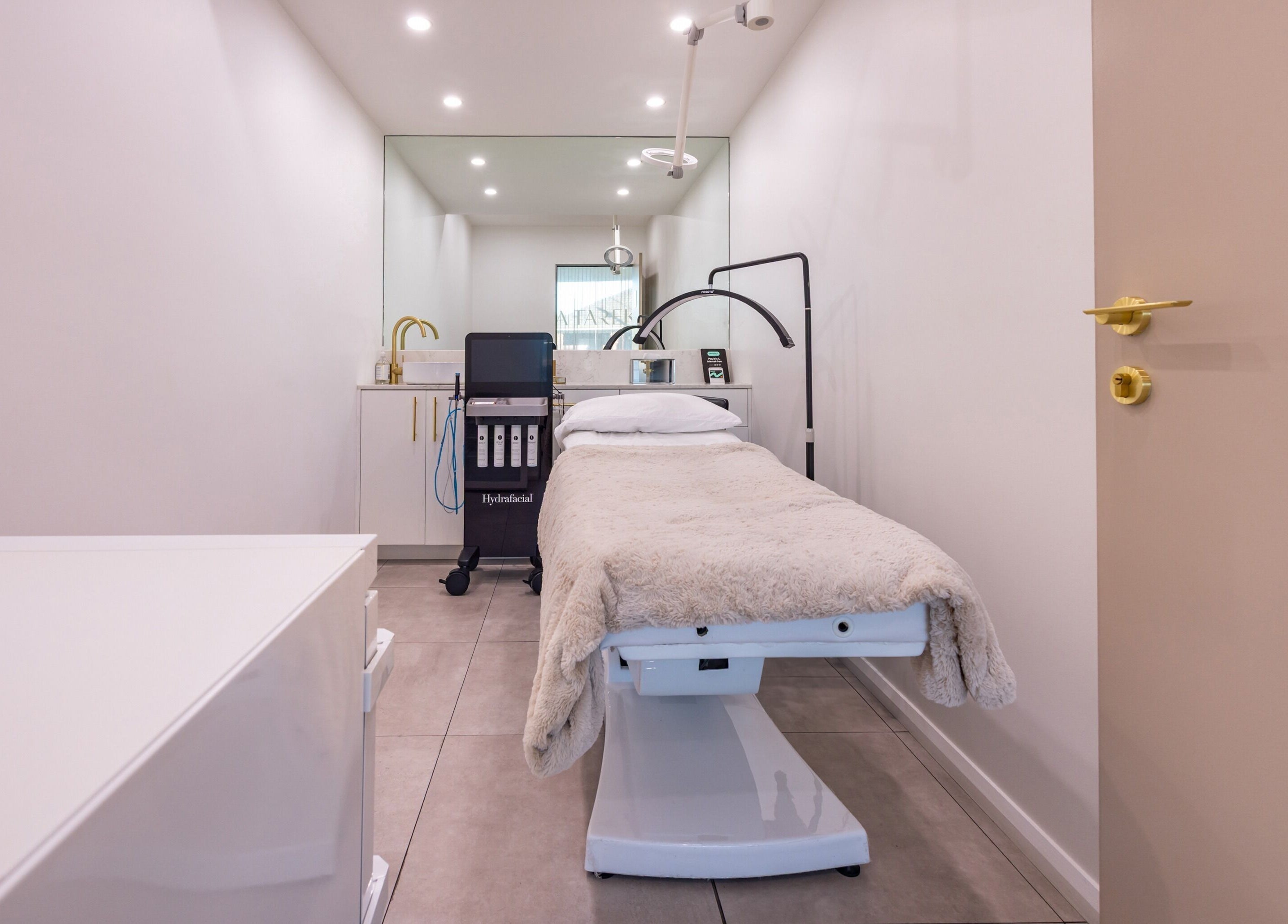 Treatment room at Lana Tarek Eyebrow Specialists, Ashfield, New South Wales, AU with a cozy bed and gold accents.