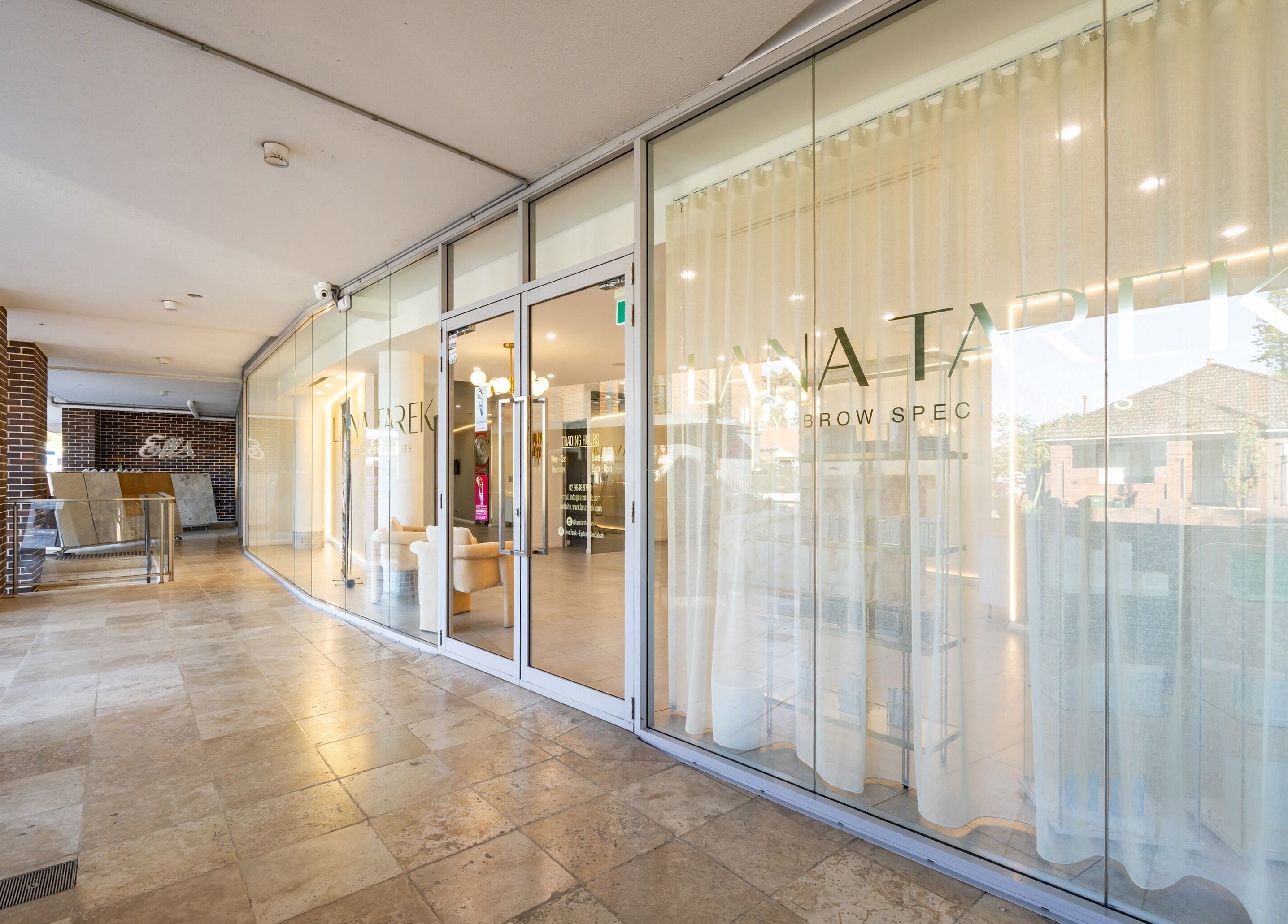 Entrance to Lana Tarek Eyebrow Specialists in Ashfield, New South Wales, AU, showing sleek modern design.