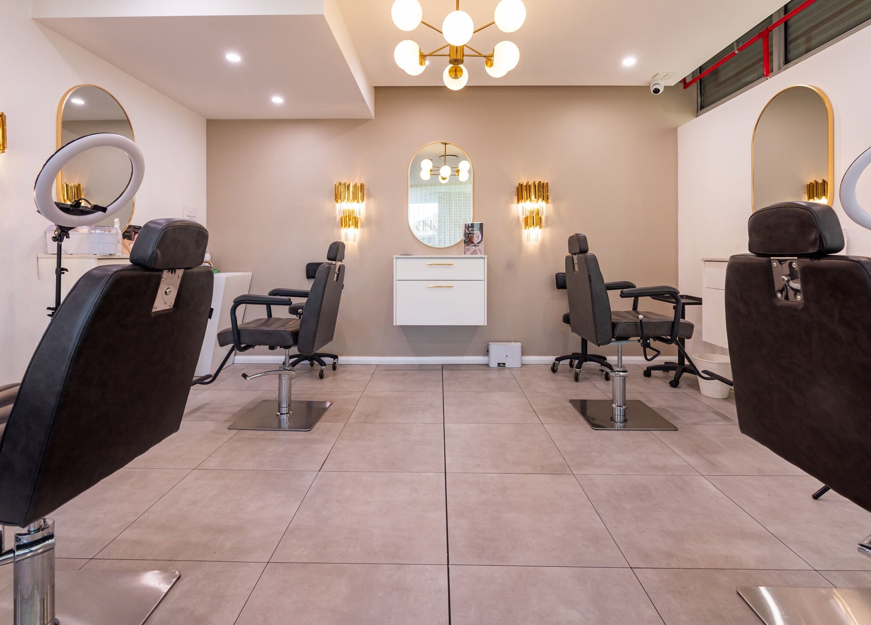 Modern interior of Lana Tarek Eyebrow Specialists in Ashfield, NSW, AU with stylish chairs and lighting.