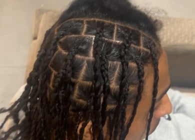 Intricate braided hairstyle created by HairbyQ in London, England, GB, showcasing precise sectioning and craftsmanship.