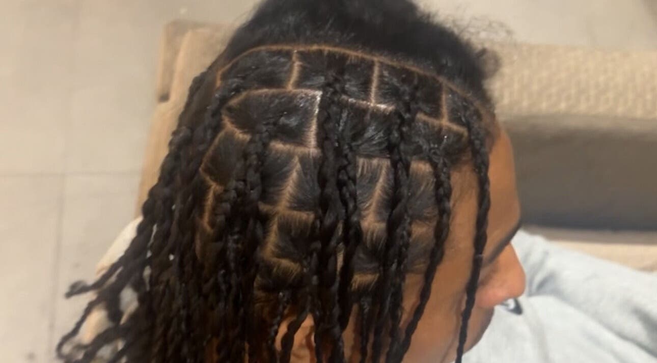 Intricate braided hairstyle created by HairbyQ in London, England, GB, showcasing precise sectioning and craftsmanship.