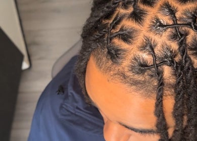 Close-up of intricate braids at HairbyQ, London, England, GB showcasing professional hair styling.