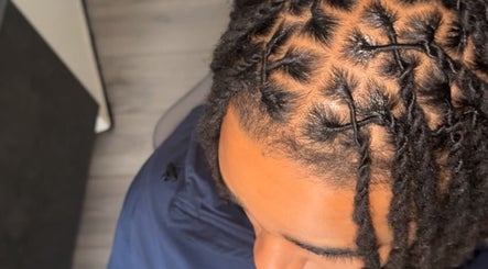 Close-up of intricate braids at HairbyQ, London, England, GB showcasing professional hair styling.