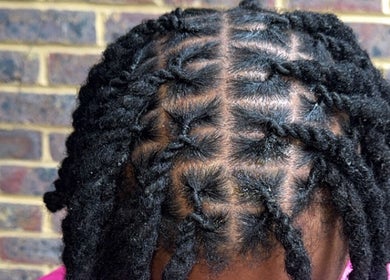 Close-up of intricate braid twists at HairbyQ, London, England, GB showcasing clean and stylish hair design.