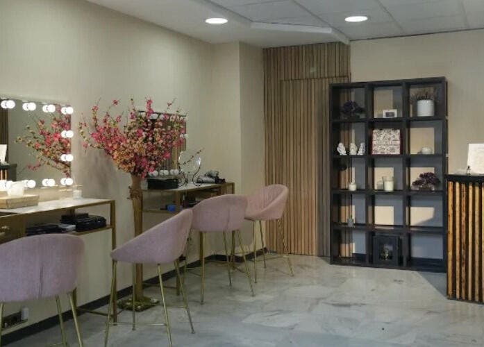 Elegante sala de espera en Inés Sánchez Beauty Concept, Granada, Andalucía, ES con sillas rosas.