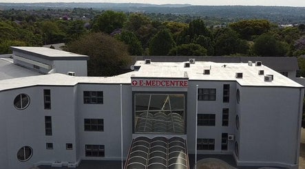 Exterior view of E-Medcentre near Meltonian Mzimba Psychologist in Randburg, Gauteng, ZA with lush greenery.