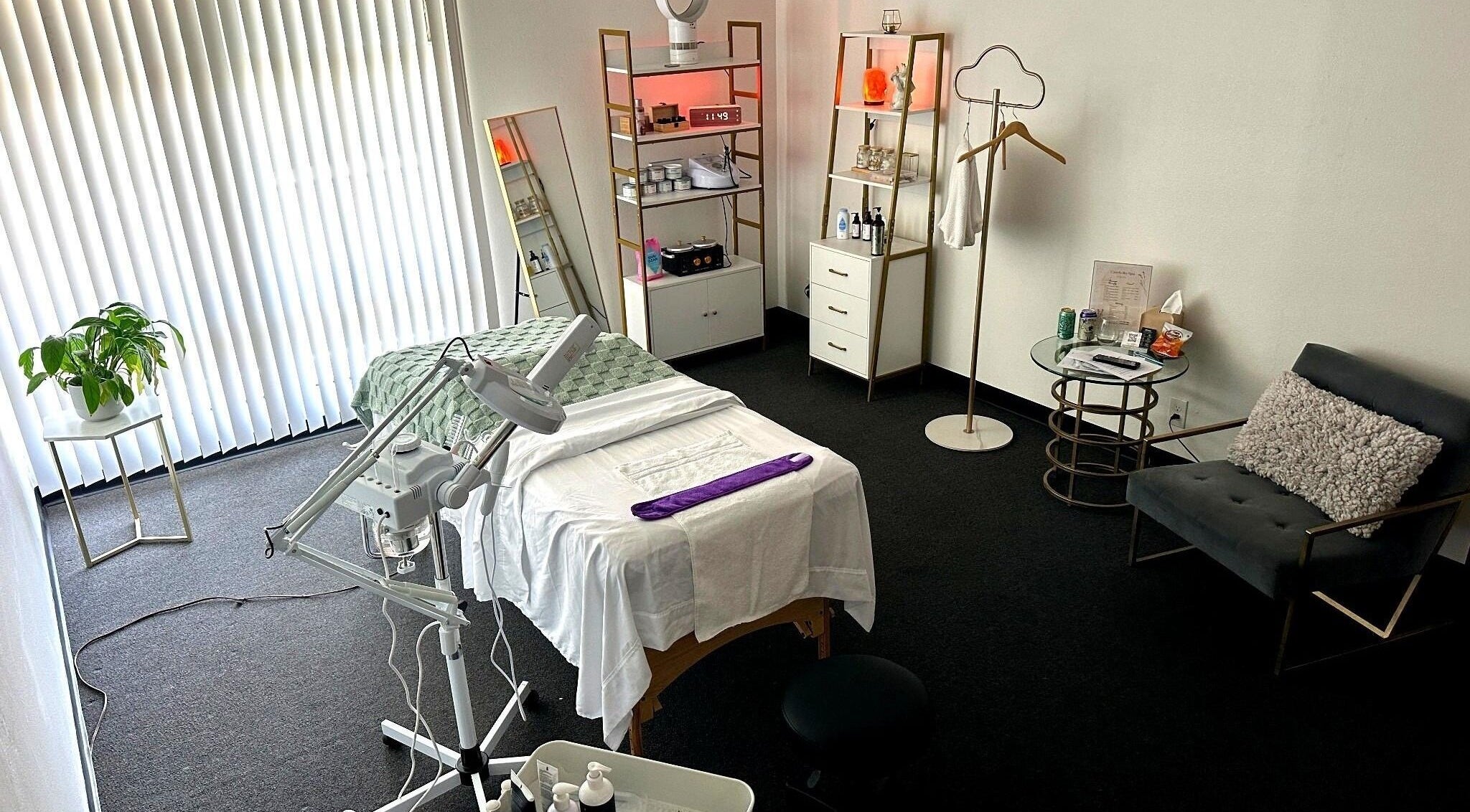 A tranquil treatment room at Lash & Glow by Oana in Newport Beach, California, US, featuring a cozy bed.