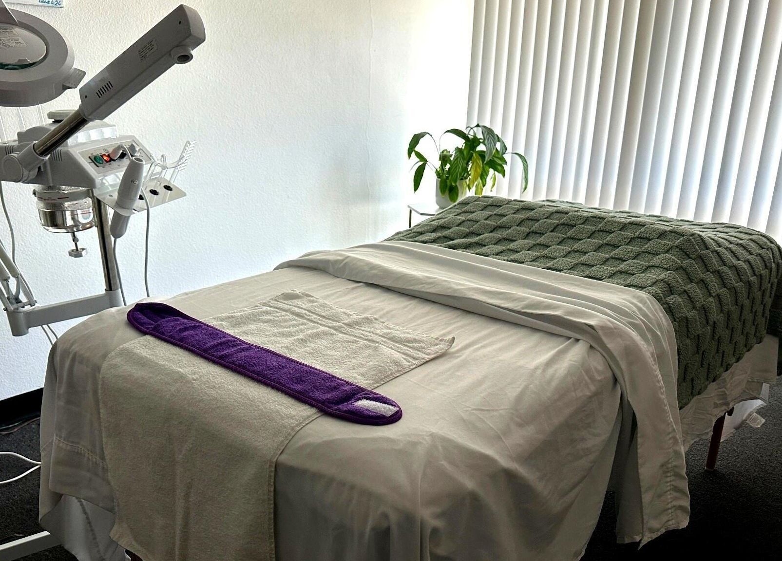 Cozy treatment room at Lash & Glow by Oana, Newport Beach, California, US, featuring a plush massage table.