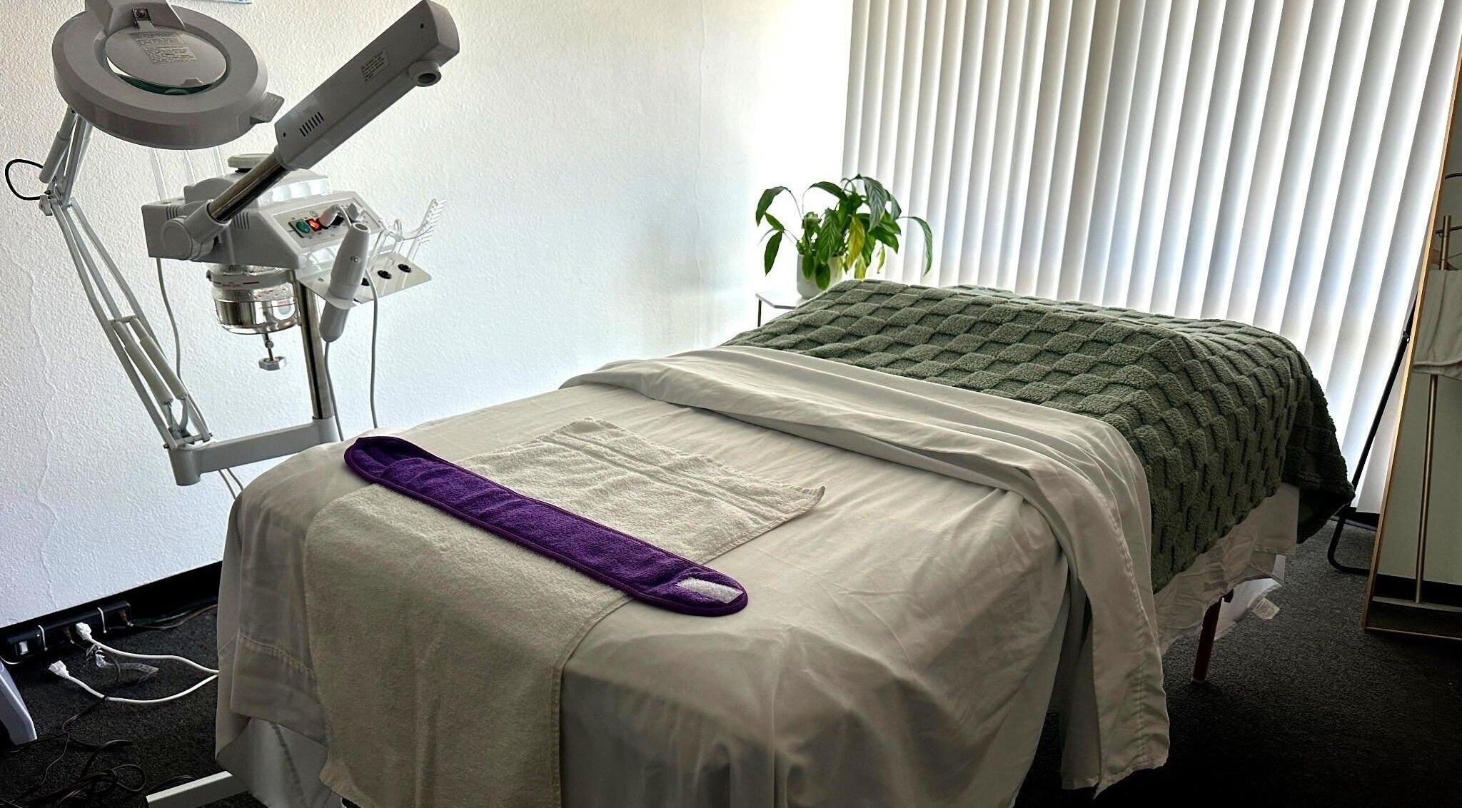 Cozy treatment room at Lash & Glow by Oana, Newport Beach, California, US, featuring a plush massage table.