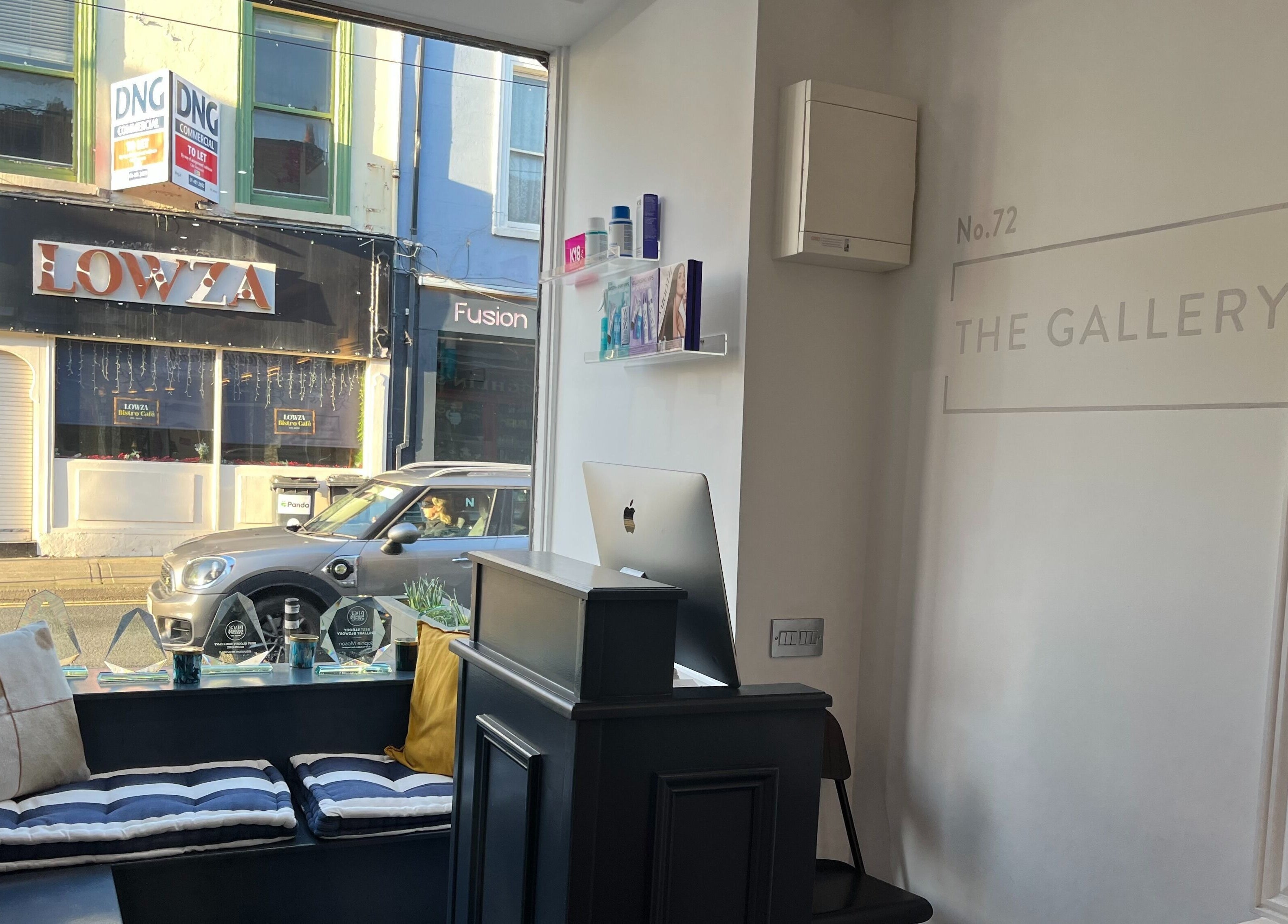 Modern interior of No.72 The Gallery, Dublin, with stylish seating and Mac setup by the window.