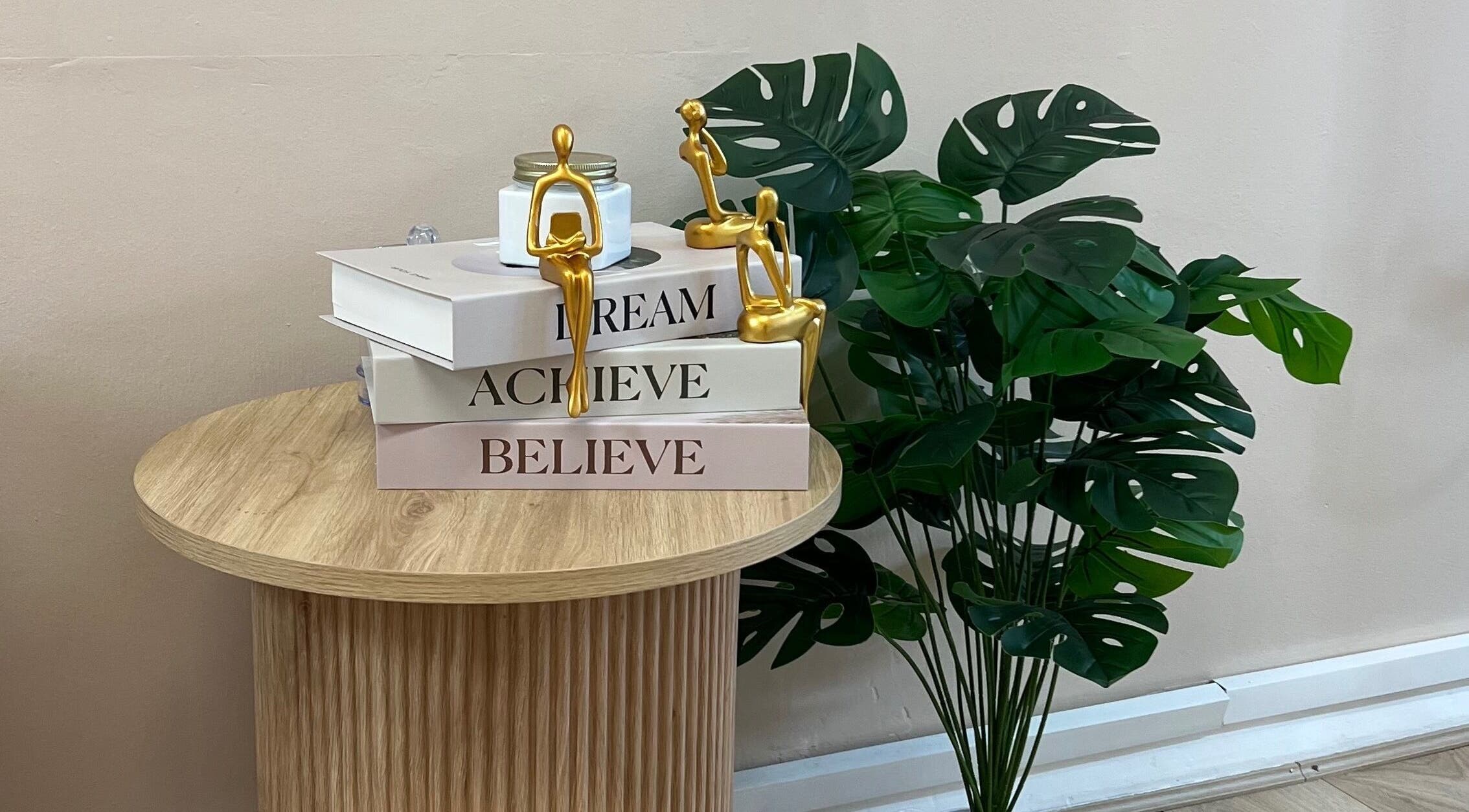 Sophisticated decor at Glamar brows studio, London, England with books and plants creating a serene atmosphere.