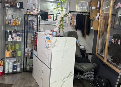 Reception area at Yocarys hair & latin in Gibsonton, Florida, US with product displays and elegant decor.