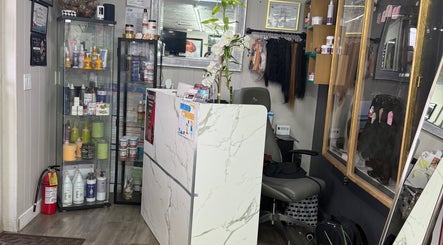 Reception area at Yocarys hair & latin in Gibsonton, Florida, US with product displays and elegant decor.