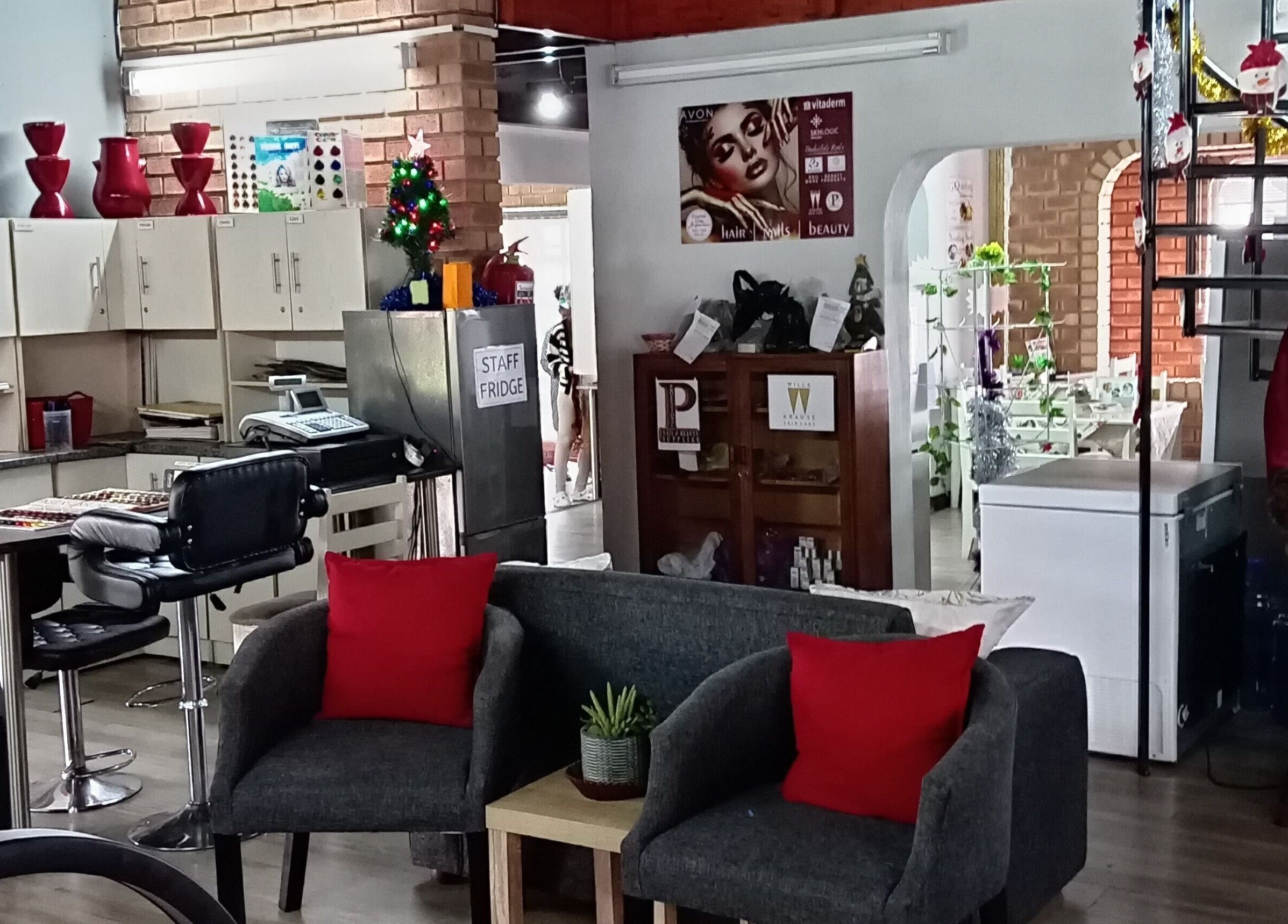 Inviting interior of Miss Vee Nails and Beauty in Pretoria, Gauteng, ZA with comfy seating and festive decor.