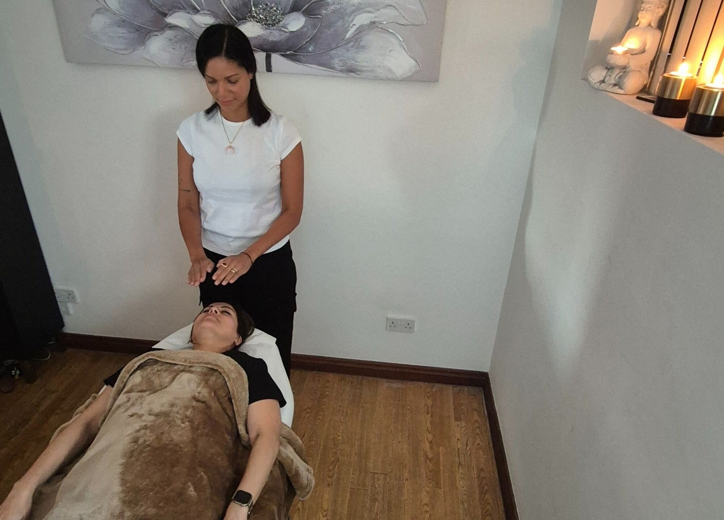 Relaxing therapy session at Vibeinwards in Ruislip, England, GB, with a practitioner offering healing touch.