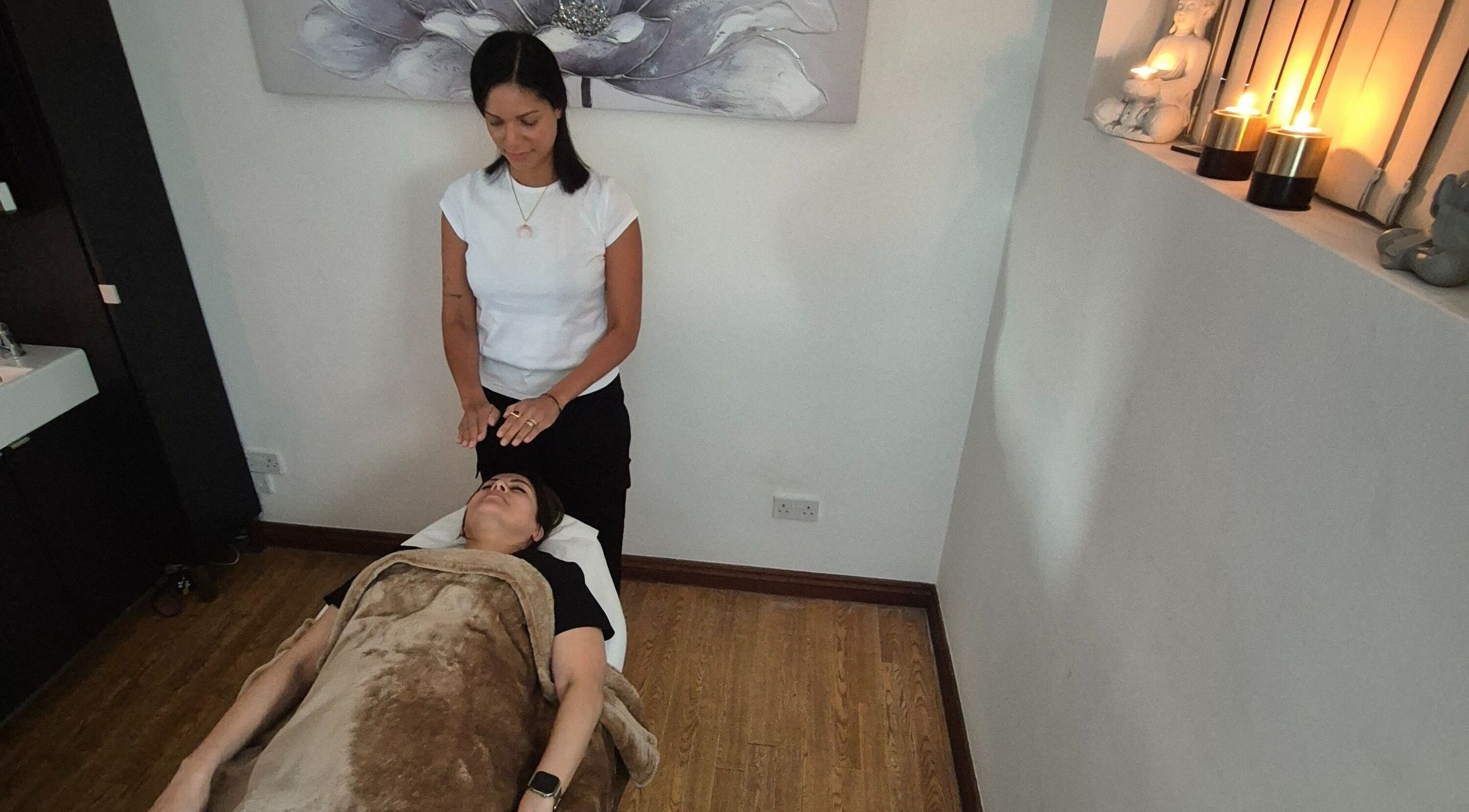 Relaxing therapy session at Vibeinwards in Ruislip, England, GB, with a practitioner offering healing touch.