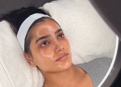 Client enjoying a facial treatment at HYDRASKIN STUDIO, London, England, GB with glowing skin.