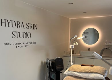 HYDRASKIN STUDIO interior in London, England, GB featuring treatment bed and illuminated mirror.