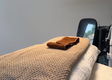 Comfortable massage bed and towel at HYDRASKIN STUDIO, London, England, GB, offering tranquility and relaxation.