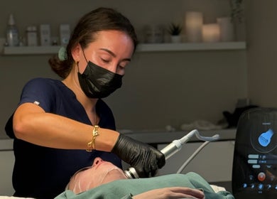 Skincare specialist at HYDRASKIN STUDIO in London, England, GB, performing a facial treatment using advanced equipment.