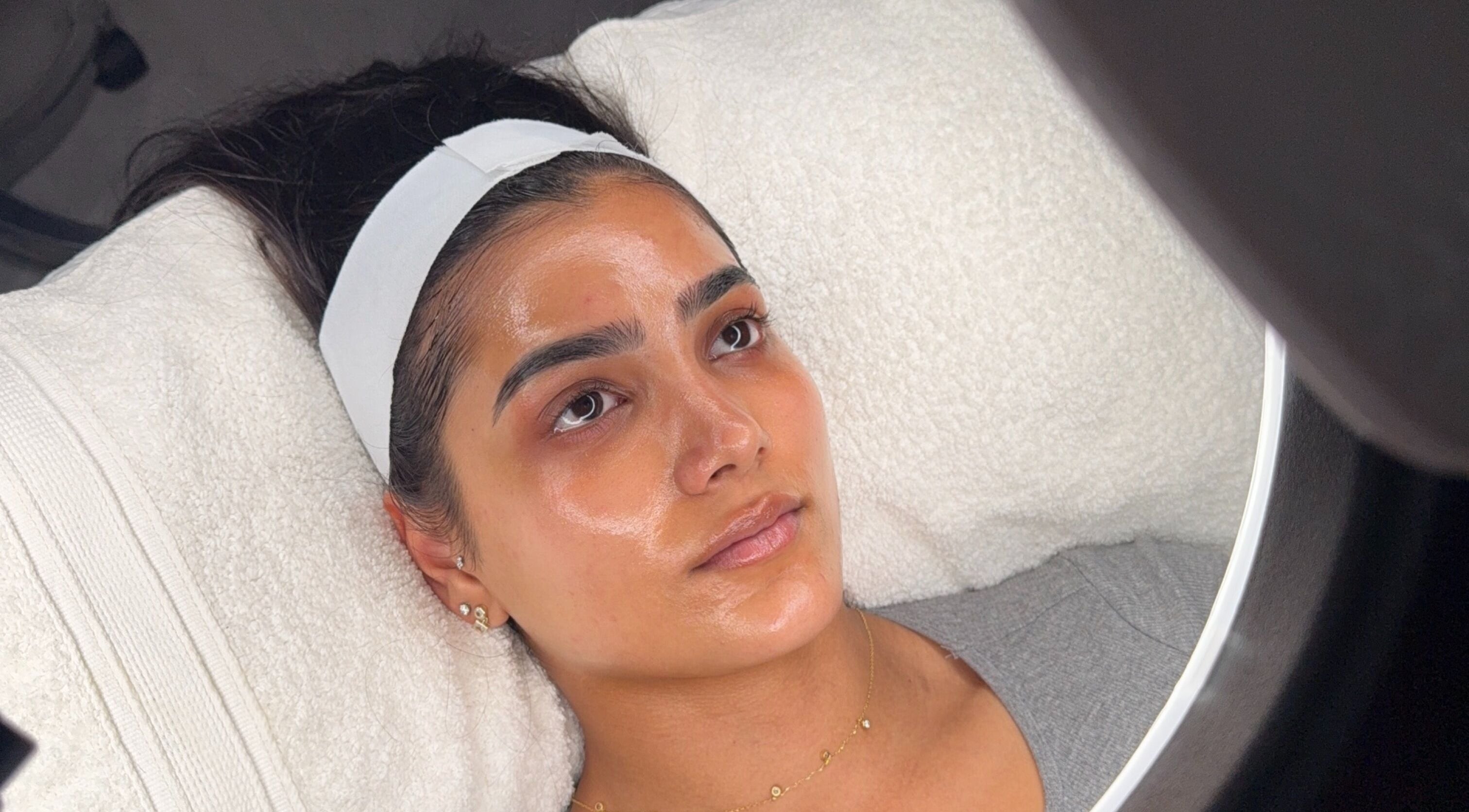Relaxing facial treatment at HYDRASKIN STUDIO, London, England, GB, showing a woman with glowing skin.